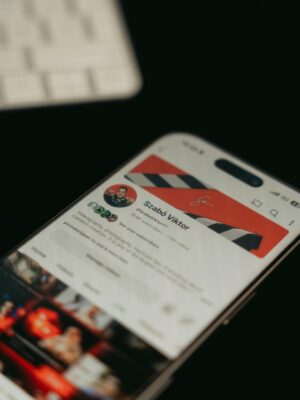 A smartphone showing a YouTube channel page screenshot in focus with blurred background.